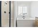 Modern bathroom with a sleek glass shower, deep soaking tub, and elegant fixtures at 39730 Congress Ln, Elizabeth, CO 80107