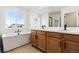 Bathroom with double sinks, soaking tub, and a large window at 39730 Congress Ln, Elizabeth, CO 80107