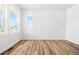 Bedroom features wood flooring, white walls, and large windows at 39730 Congress Ln, Elizabeth, CO 80107