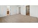 Spacious bedroom featuring neutral carpet, white walls, a walk in closet, and an ensuite bath at 39730 Congress Ln, Elizabeth, CO 80107