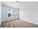 Bedroom featuring neutral carpet, white walls and two large windows at 39730 Congress Ln, Elizabeth, CO 80107