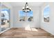 Bright dining room with a modern chandelier, large windows, and lots of natural light at 39730 Congress Ln, Elizabeth, CO 80107