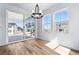 Dining room with modern chandelier, large sliding glass doors, and lots of natural light at 39730 Congress Ln, Elizabeth, CO 80107
