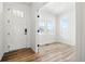 Entryway features wood flooring, white walls, and a sidelight front door at 39730 Congress Ln, Elizabeth, CO 80107