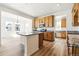Bright kitchen features granite countertops, an island, stainless steel appliances and light wood cabinets at 39730 Congress Ln, Elizabeth, CO 80107