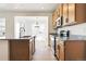 Bright kitchen features granite countertops, stainless steel appliances and light wood cabinets at 39730 Congress Ln, Elizabeth, CO 80107
