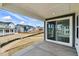 Covered patio offers a seamless indoor-outdoor transition with sliding glass doors overlooking the backyard at 39730 Congress Ln, Elizabeth, CO 80107