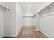 Spacious walk-in closet with carpet flooring, white walls, and installed shelving at 39730 Congress Ln, Elizabeth, CO 80107