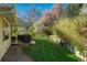Backyard featuring covered patio, grill and a lush lawn with mature trees at 7169 S Grape Ln, Centennial, CO 80122