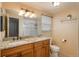 Bathroom featuring granite countertops, wood cabinets, and a shower, designed for convenience and comfort at 7169 S Grape Ln, Centennial, CO 80122