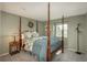 Bedroom with four poster bed, carpet, neutral paint, providing a serene and inviting atmosphere at 7169 S Grape Ln, Centennial, CO 80122