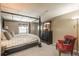 Comfortable bedroom with a four-poster bed, neutral color scheme, and a decorative chest of drawers at 7169 S Grape Ln, Centennial, CO 80122