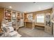 Craft room featuring storage, carpeting, and a built in work desk with convenient storage and comfortable seating at 7169 S Grape Ln, Centennial, CO 80122