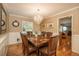 Traditional dining room with chandelier, hardwood floors, wainscoting, and elegant wood furniture for gatherings at 7169 S Grape Ln, Centennial, CO 80122