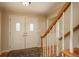 Inviting entryway with decorative glass front doors, wood staircase, and neutral decor at 7169 S Grape Ln, Centennial, CO 80122