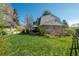 Backyard view of home with covered patio, lush lawn, and mature trees at 7169 S Grape Ln, Centennial, CO 80122