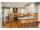 Inviting kitchen with granite countertops, stainless steel appliances, custom cabinets, and hardwood flooring at 7169 S Grape Ln, Centennial, CO 80122