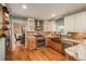 Updated kitchen with custom cabinetry, granite counters, stainless appliances, and hardwood floors for cooking at 7169 S Grape Ln, Centennial, CO 80122