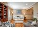 Bright living room with hardwood floors, neutral paint, wainscoting, and recessed lighting exudes relaxation at 7169 S Grape Ln, Centennial, CO 80122