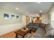This living room boasts hardwood floors, beachy wall decor, and seamless access to the eat-in kitchen at 7169 S Grape Ln, Centennial, CO 80122