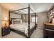 Bedroom with four-poster bed, carpet, and neutral color palette providing a relaxing retreat within the home at 7169 S Grape Ln, Centennial, CO 80122