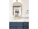 Stylish basement bathroom vanity with marble countertop, gold fixtures, and modern mirror at 2235 S Fillmore St, Denver, CO 80210