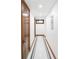 Finished basement hallway with tiled floor detail and a window with wood trim at 2235 S Fillmore St, Denver, CO 80210