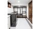 Basement laundry area with modern washer and dryer, complemented by built-in storage and stylish flooring at 2235 S Fillmore St, Denver, CO 80210