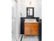 Bathroom boasting a single sink wood vanity, marble countertop and modern mirror at 2235 S Fillmore St, Denver, CO 80210
