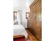 Bedroom featuring wood floors, a large wardrobe, and wood-framed windows at 2235 S Fillmore St, Denver, CO 80210