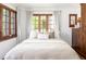 Bright bedroom with natural light, neutral decor, and wood-framed windows at 2235 S Fillmore St, Denver, CO 80210