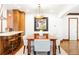 Bright dining room featuring a wooden table, white chairs, brick wall accent and unique light fixture at 2235 S Fillmore St, Denver, CO 80210