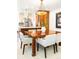 Elegant dining area with a large wooden table, comfortable seating, and stylish lighting fixture at 2235 S Fillmore St, Denver, CO 80210