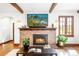 Living room showcasing a brick fireplace, wooden beams, and natural light from large windows at 2235 S Fillmore St, Denver, CO 80210