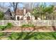 Charming exterior view of the home with a white picket fence and well-manicured landscaping at 2235 S Fillmore St, Denver, CO 80210