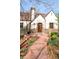 Charming Tudor-style home with brick walkway, manicured landscaping, and inviting front entrance at 2235 S Fillmore St, Denver, CO 80210