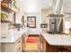Gourmet kitchen featuring white countertops, stainless steel appliances, wood floors, and natural light at 2235 S Fillmore St, Denver, CO 80210