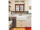 Charming kitchen sink featuring white cabinets, a farmhouse sink, and natural light at 2235 S Fillmore St, Denver, CO 80210