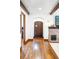 View of living room with wooden beams, brick fireplace, and hardwood floors at 2235 S Fillmore St, Denver, CO 80210