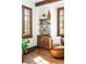 Comfortable living room with built-in bookshelves, a cozy chair, and large windows for natural light at 2235 S Fillmore St, Denver, CO 80210