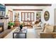 Cozy living room featuring a fireplace, large windows, wooden beams, and stylish furniture at 2235 S Fillmore St, Denver, CO 80210