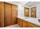 Bathroom with wooden vanity and sliding closet doors at 2883 W Long Cir # E, Littleton, CO 80120