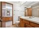 Bright bathroom with wooden vanity featuring a toilet at 2883 W Long Cir # E, Littleton, CO 80120