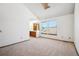 Bedroom with vaulted ceiling, large windows, and adjoined bath at 2883 W Long Cir # E, Littleton, CO 80120