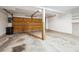 A garage features a door, support beam, shelves and trashcan at 2883 W Long Cir # E, Littleton, CO 80120
