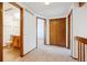 Hallway featuring carpet, doors to rooms, and a vent at 2883 W Long Cir # E, Littleton, CO 80120