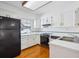 Classic kitchen with white countertops and cabinets paired with wood floors at 2883 W Long Cir # E, Littleton, CO 80120