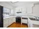 Classic kitchen with white countertops and cabinets paired with wood floors at 2883 W Long Cir # E, Littleton, CO 80120