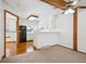 Cozy kitchen featuring white cabinets and an adjoining living area at 2883 W Long Cir # E, Littleton, CO 80120