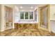 Elegant bathroom featuring a soaking tub, glass-enclosed shower, and large picture window at 5080 Barn Swallow Way, Parker, CO 80134